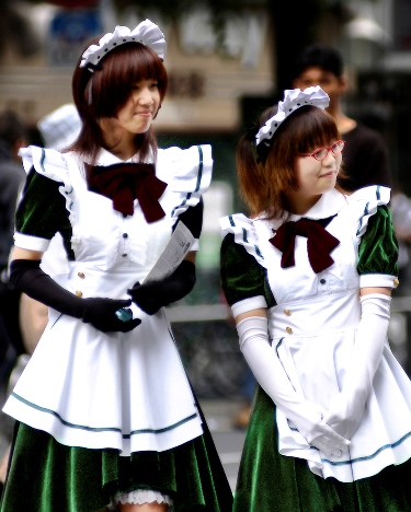 Promoting a maid-kissa (メイド喫茶 meido-kissa, 'maid coffee shop') in Akihabara, Tokyo will involve looking the part; young women in maidlike waitresses' outfits are a common sight in this electronics quarter of the city. Photo © by Sonny Santos, used by permission.