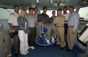 US Navy Tiger Woods poses in admiral chair.jpg