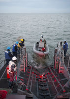USS Monsoon launches a rigid-hull inflatable boat.