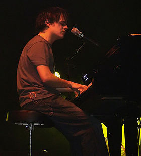 Person playing the piano on stage.