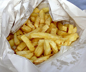 Chips wrapped in paper, as customarily served in the United Kingdom. Potatoes used to prepare chips are sliced thicker than many french fry varieties, setting them apart from "french fries" in the minds of many Brits.
