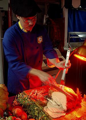 428px-US Navy 061123-N-1598C-004 Culinary Specialist Seaman Eric Trute carves a turkey in preparation for the Thanksgiving Day meal on the mess decks of the amphibious assault ship USS Saipan (LHA 2).jpg